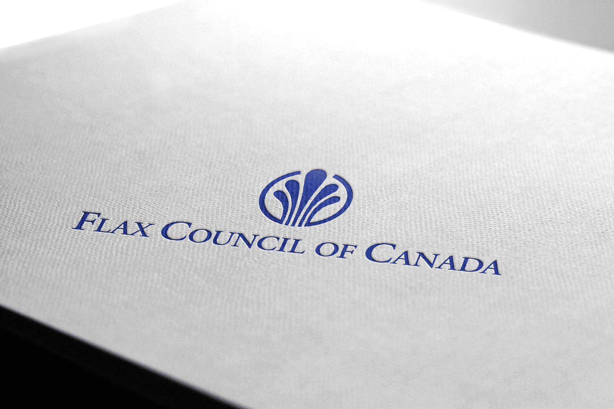 Flax Logo The Flax Council of Canada logo in a deep indigo colour embossed on roughly textured stationary.